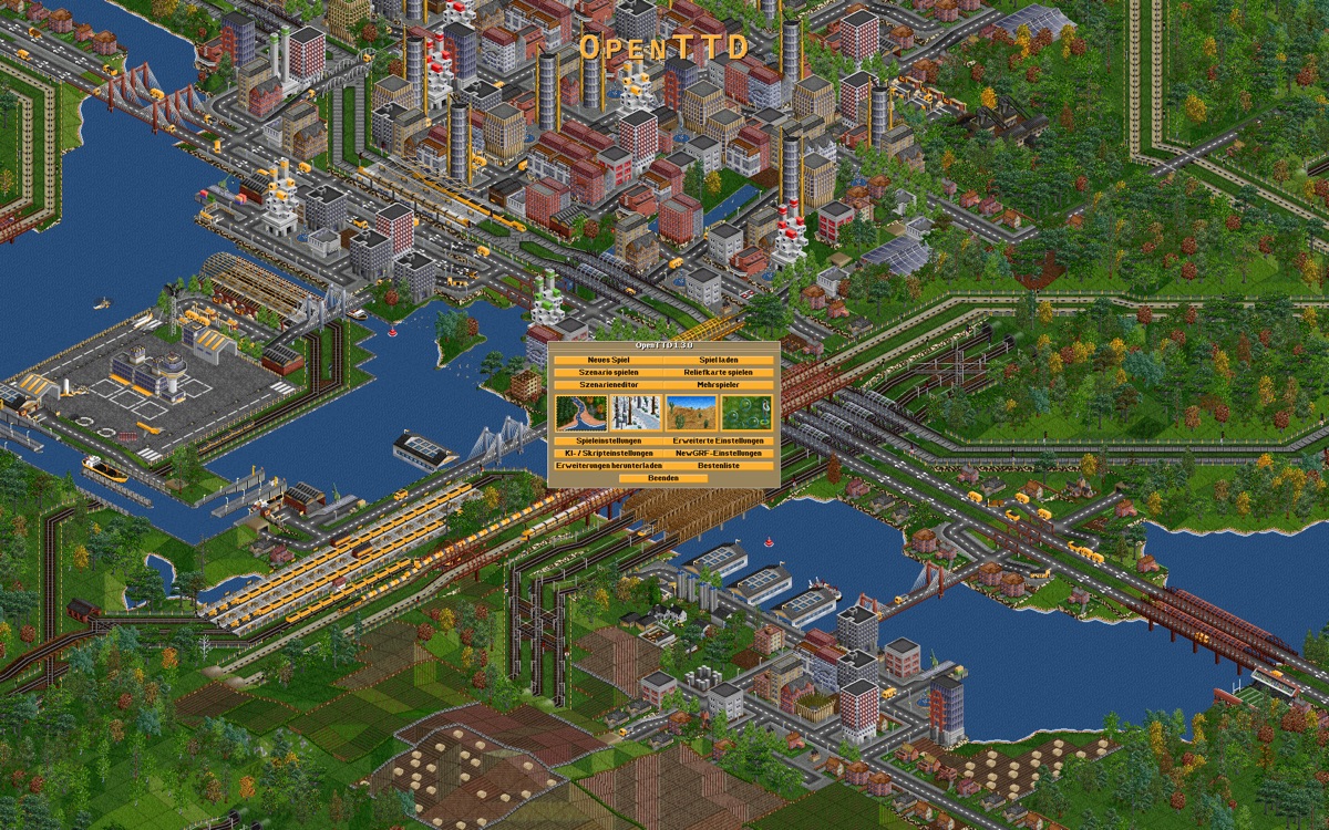 OpenTTD OpenGFX title screen showing dense rail, road, ship, city, and industry networks